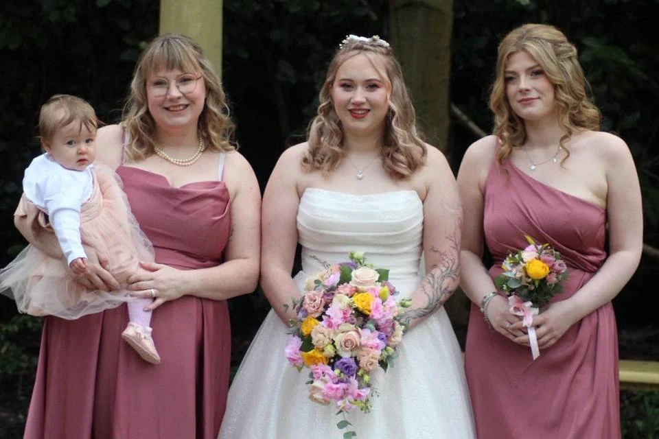 Bride with bridesmaids in rose dresses